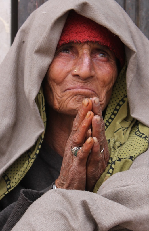 Backroads with Betsy Motorcycling in the Himalayas woman praying