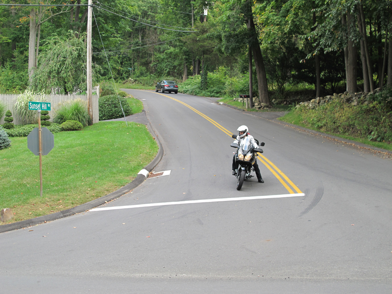 Make it a habit to secure all your luggage so that the load is evenly distributed on your bike and get used to leaning slightly to the left when you stop. That way, you’re still able to use your rear brake pedal to make a complete stop as you put your left foot down first.