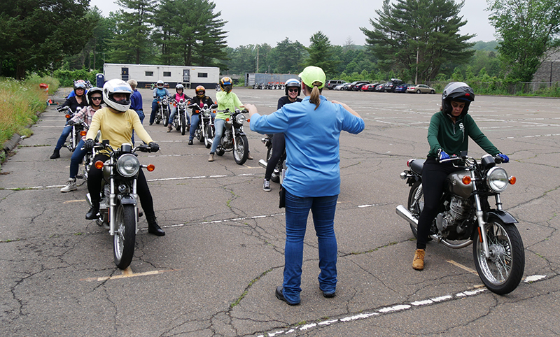 During the range portion of the class, students head out to the parking lot to learn and practice riding skills on provided small displacement motorcycles.