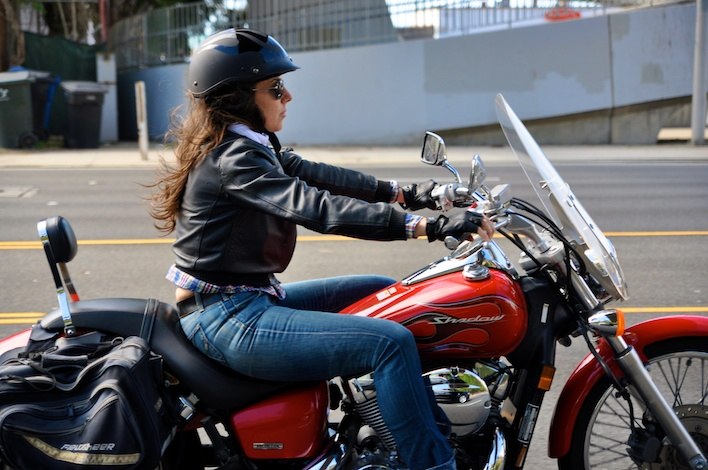 Woman riding motorcycle hot sale