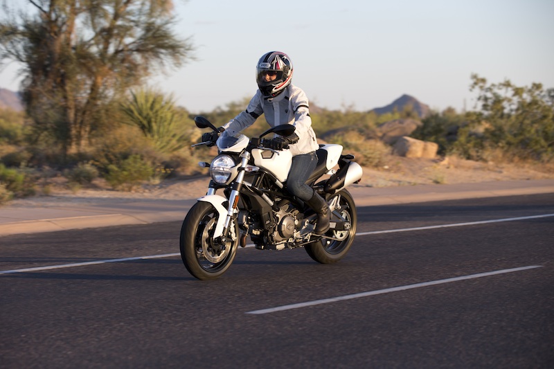 Motorcycle review 2014 Ducati Monster woman riding desert road