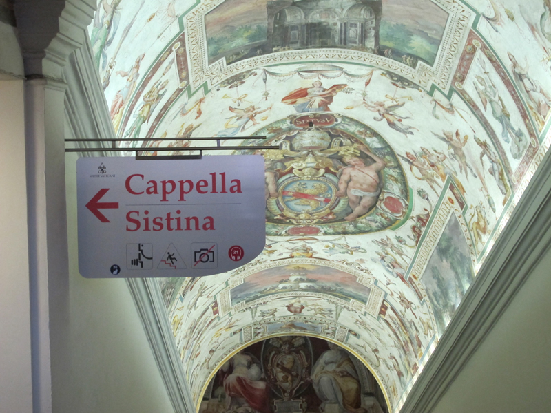 why you should ride a motorcycle in italy once in your life sistine chapel sign