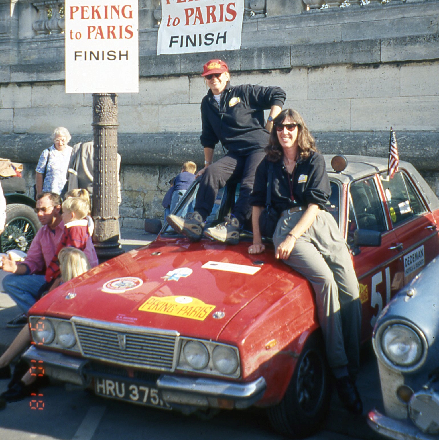 The female first-time car racing duo celebrating their wins at the finish line in Paris.