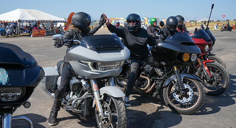 Karen Davidson and Shelly Rossmeyer Pepe high five on motorcycles