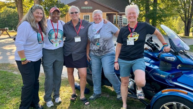 Picture16 WIMA USA President Michelle Lamphere chats with Motor Maids from New England. The Motor Maids are hailed as being one of the oldest women’s motorcycling organizations and have been intertwined with WIMA for decades.
